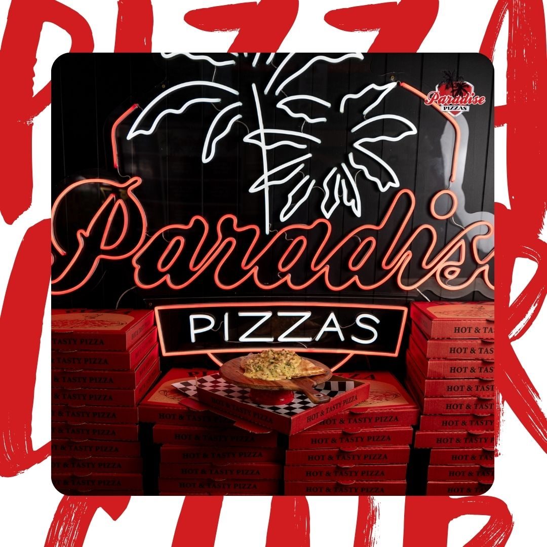 Paradise Pizzas red and white neon on the slat wall