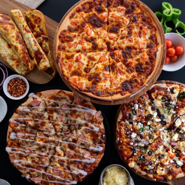 Three pies on black — tomato, meat drizzle, Mediterranean